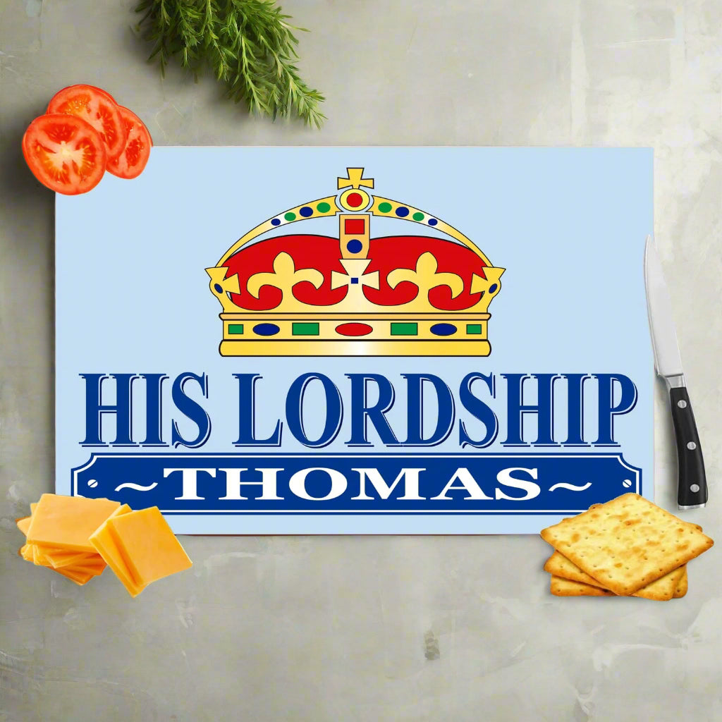 Personalized cutting board with a crown design and text, surrounded by food items on a white background.