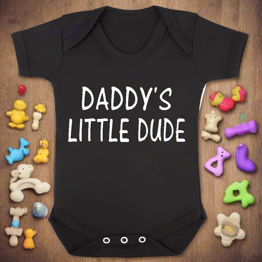 Black baby onesie with 'Daddy's Little Dude' text on a white background