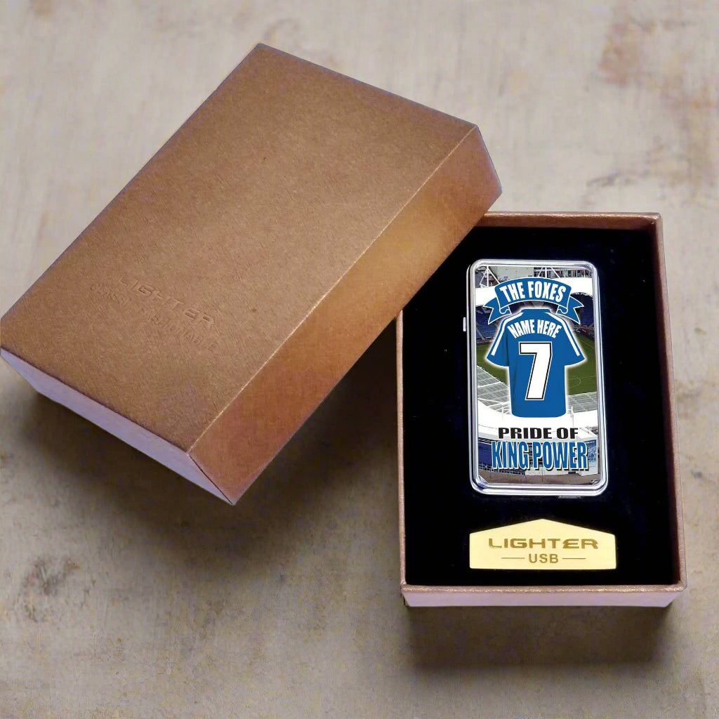 Lighter with a printed design in an open brown box on a white background