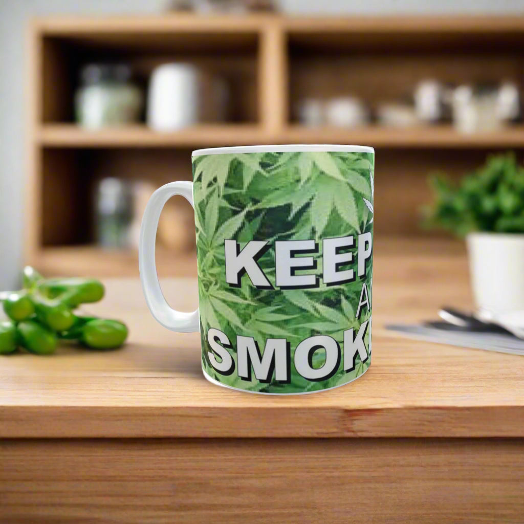 Mug with cannabis leaf pattern and text 'KEEP IT SMOKIN' on a white background
