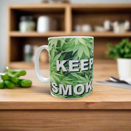 Mug with cannabis leaf pattern and text 'KEEP IT SMOKIN' on a white background