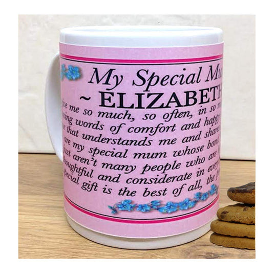 Pink mug with text and floral design on a wooden surface