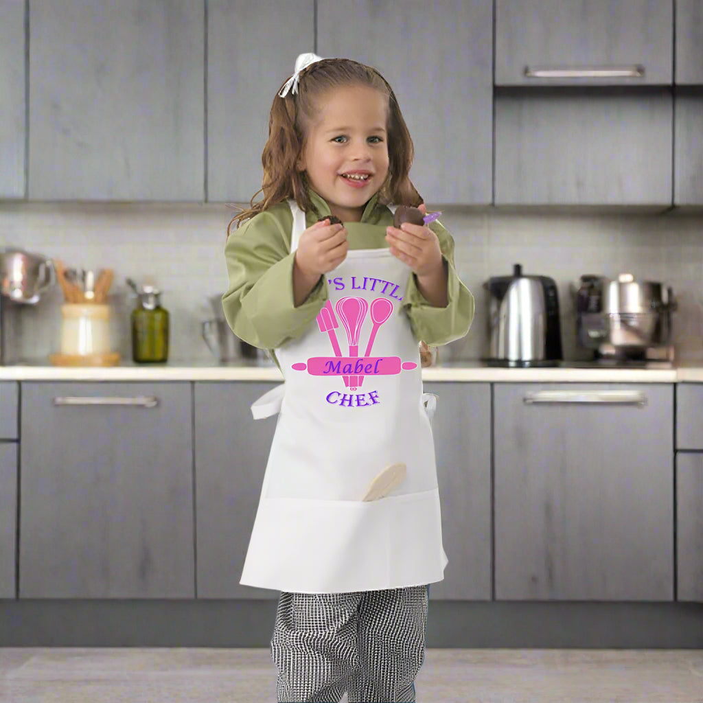 Child wearing a personalized apron with a chef design on a white background