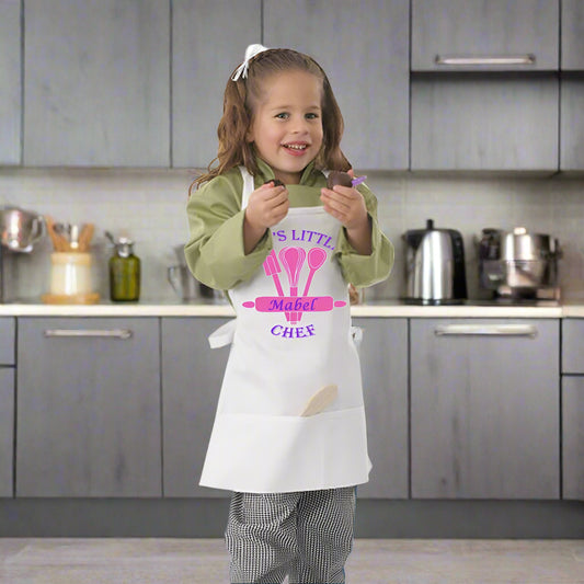 Child wearing a personalized apron with a chef design on a white background